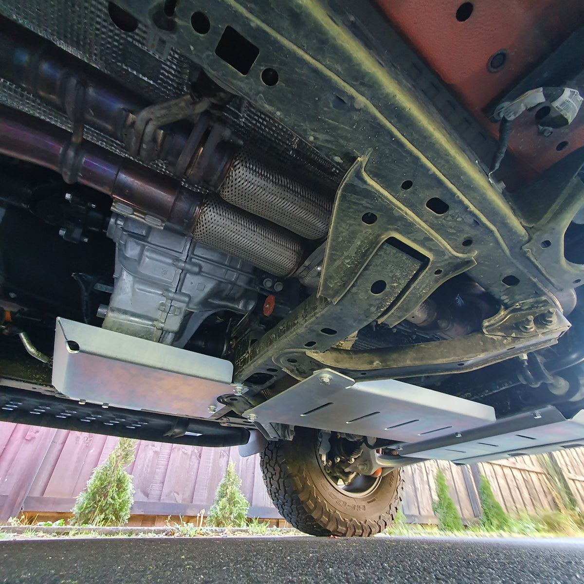 Rearward underside view of Raptor bash plates and separate transfer case guard below the housing