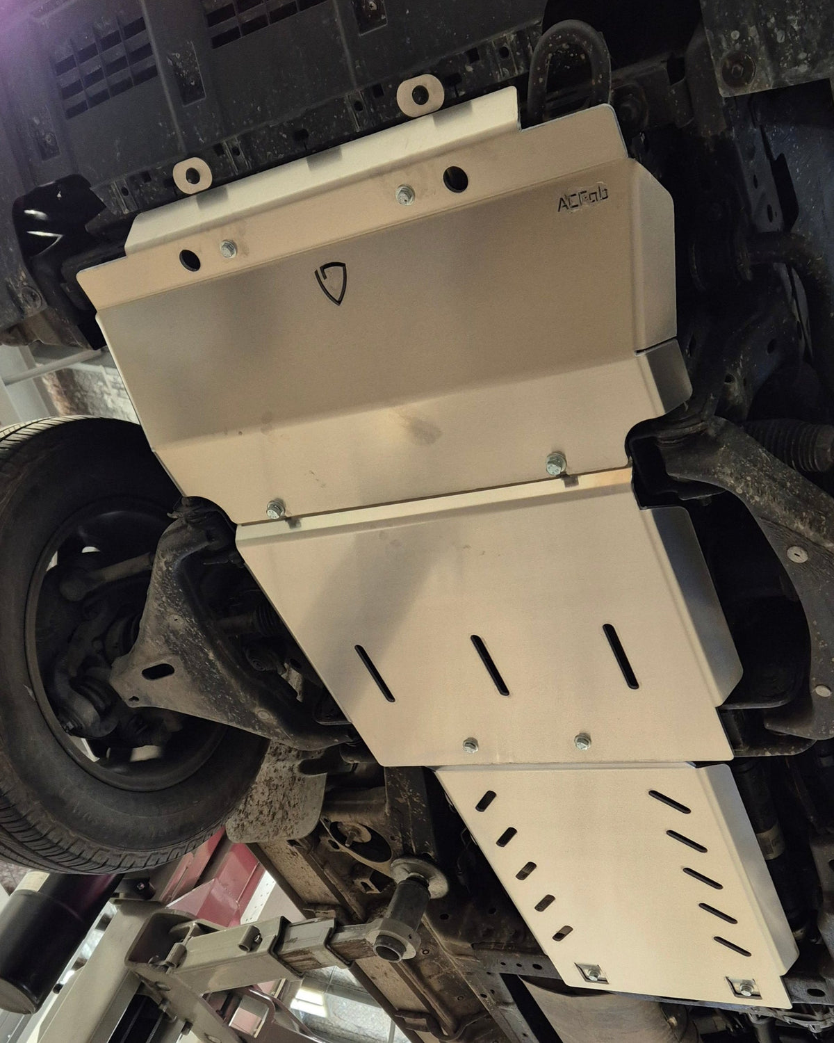 Car undercarriage inspection or repair in a workshop setting