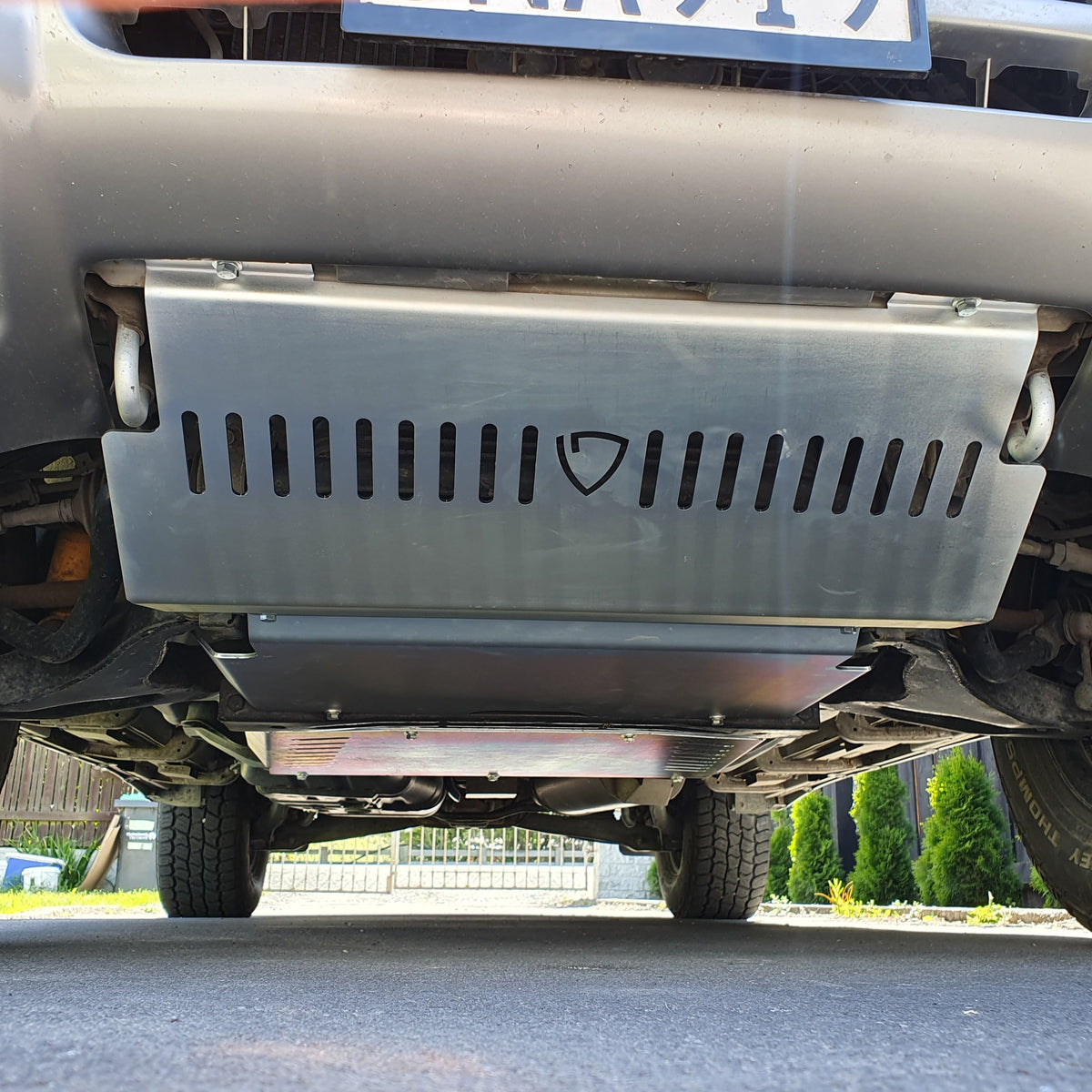 Low front view of Pajero Gen 3 bash plates showing vertical vents and shield cut-out beneath the bumper