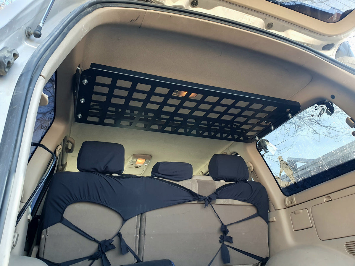 Opposite rear angle of Landcruiser 100 cargo shelf beneath the open hatch