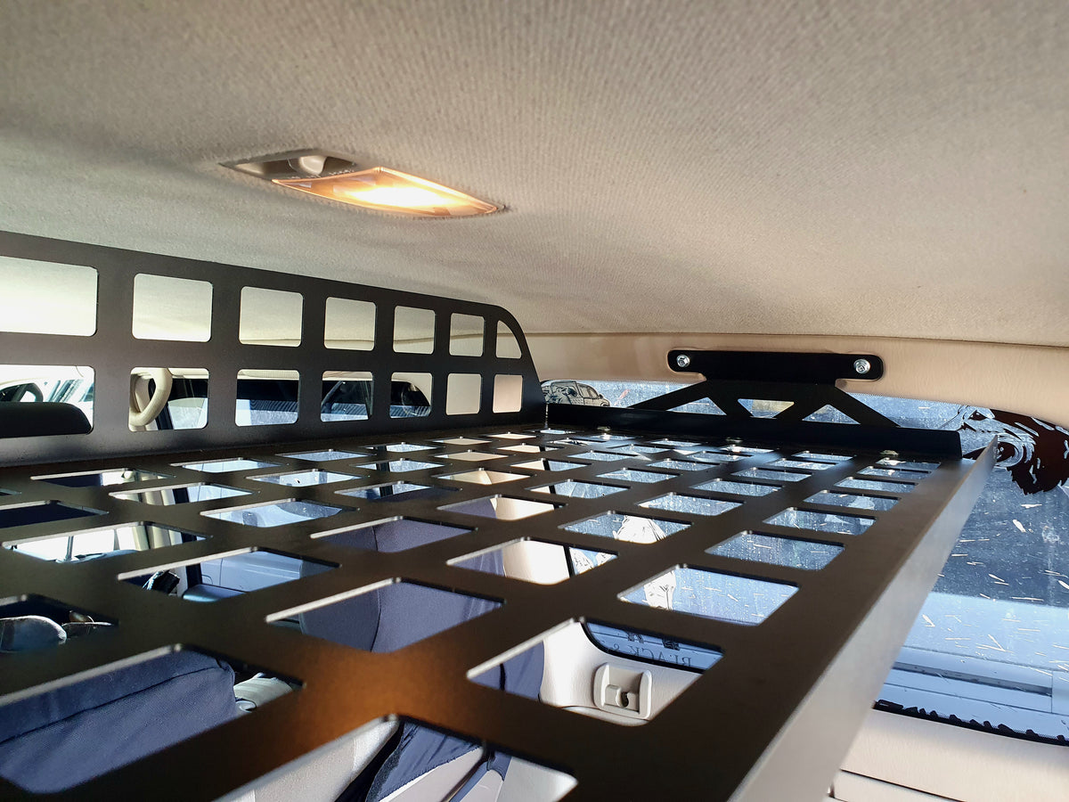 Close-up of Landcruiser 100 cargo shelf grid base, raised front lip and right mounting bracket
