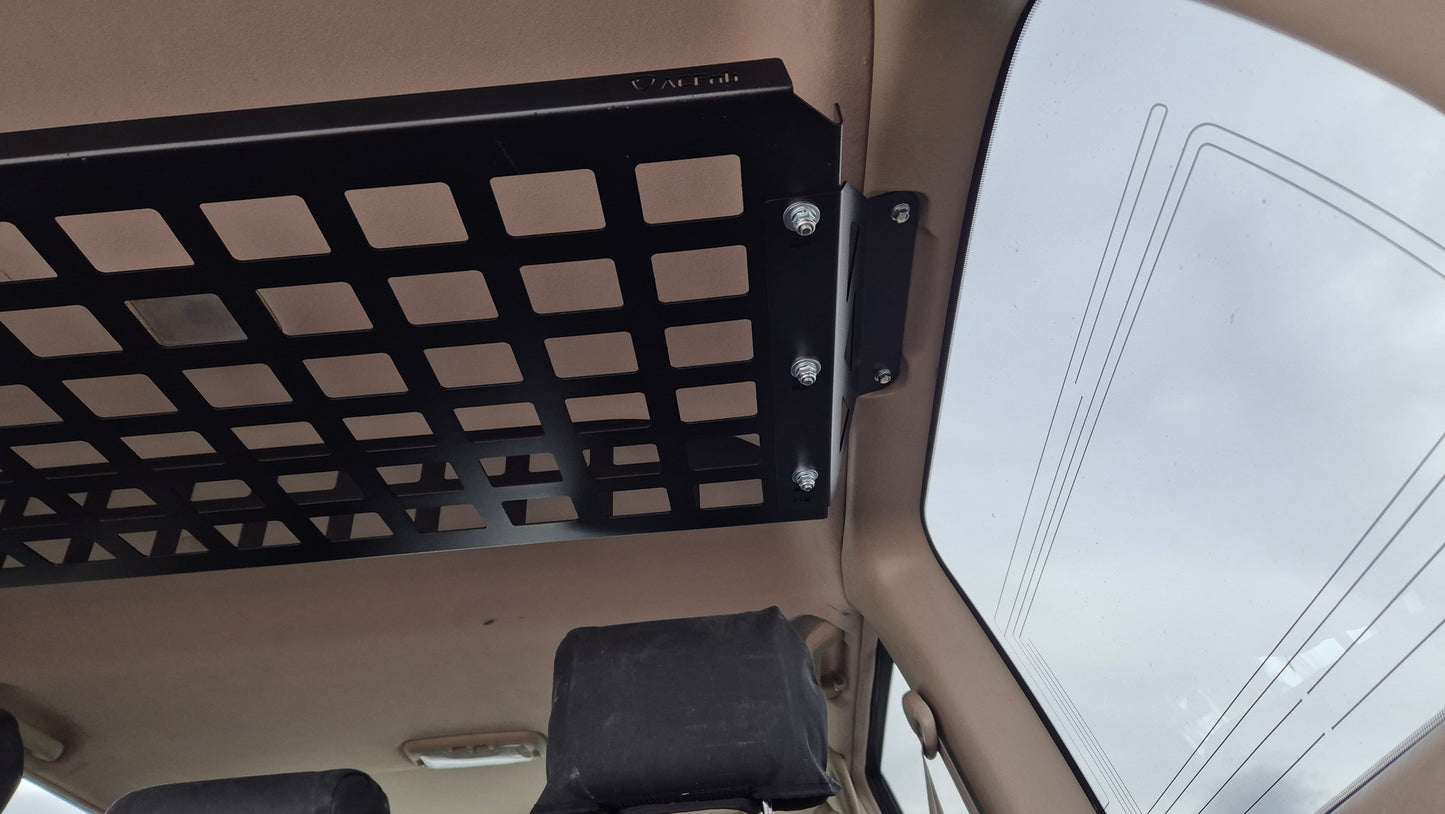 Black metal grid attached to a vehicle's interior ceiling
