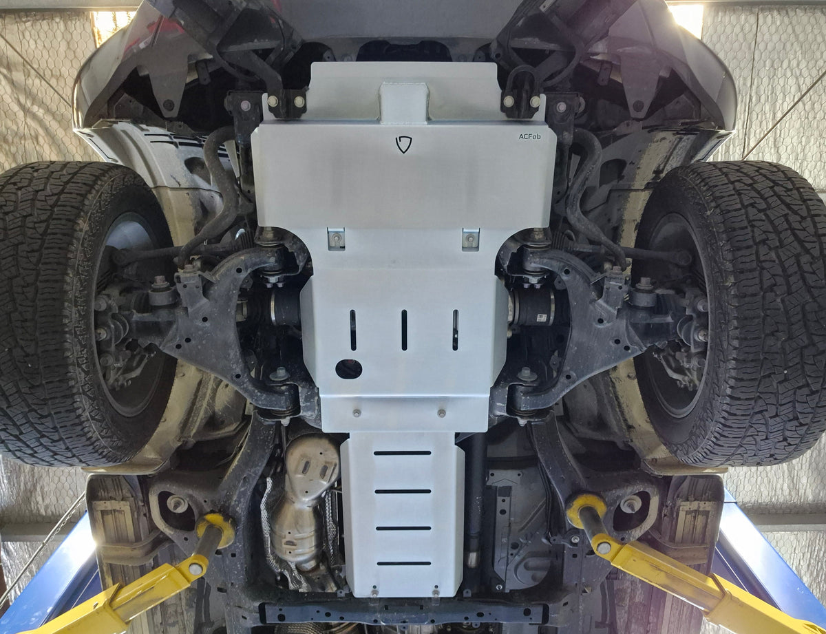 Full underside view of Landcruiser 300 bash plates showing three panels, ventilation slots and round access opening