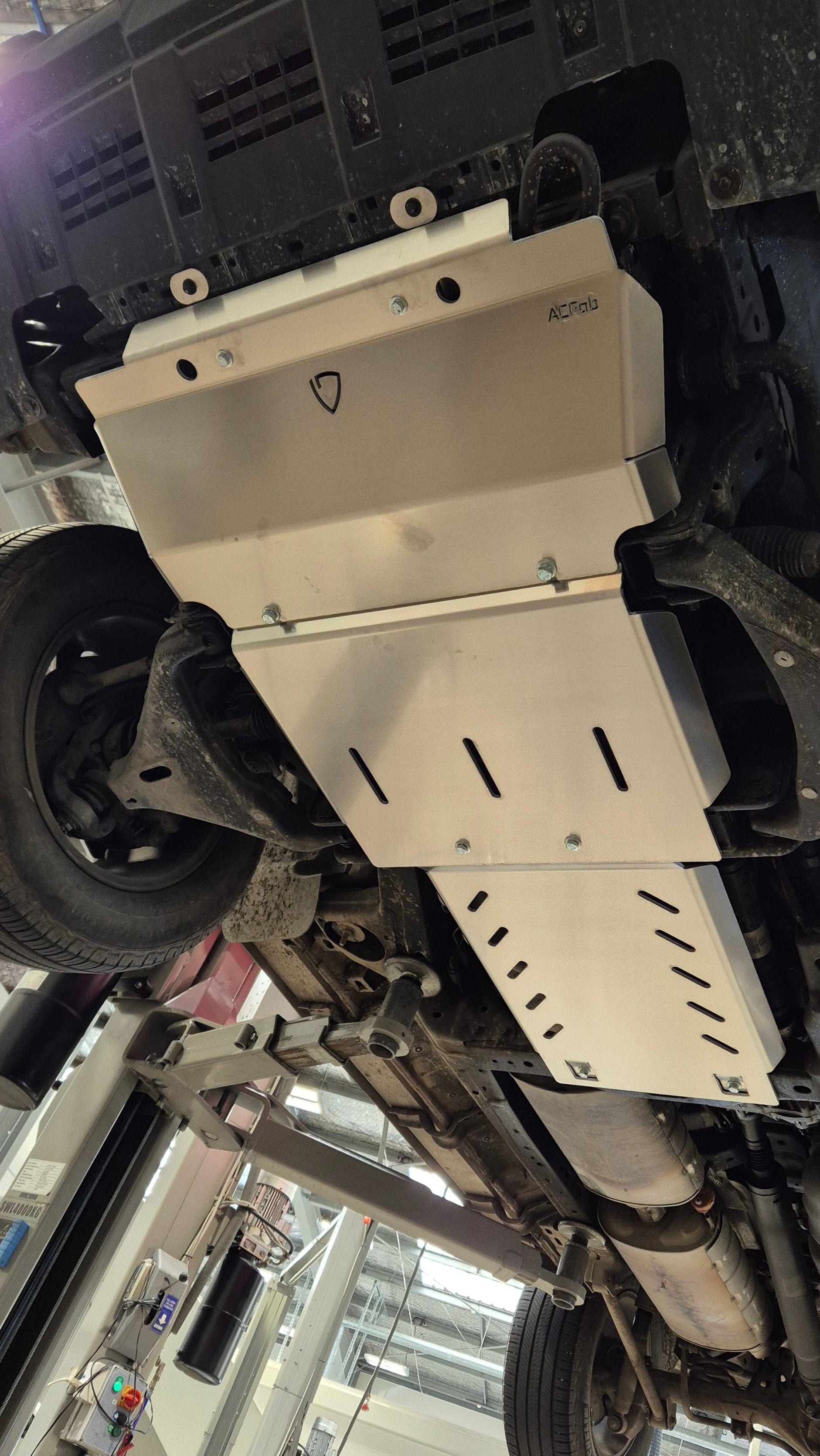 Car undercarriage inspection or repair in a workshop setting