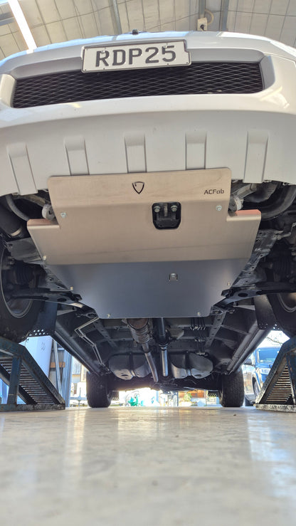Close-up of a vehicle's front grille with a visible license plate in an indoor setting.