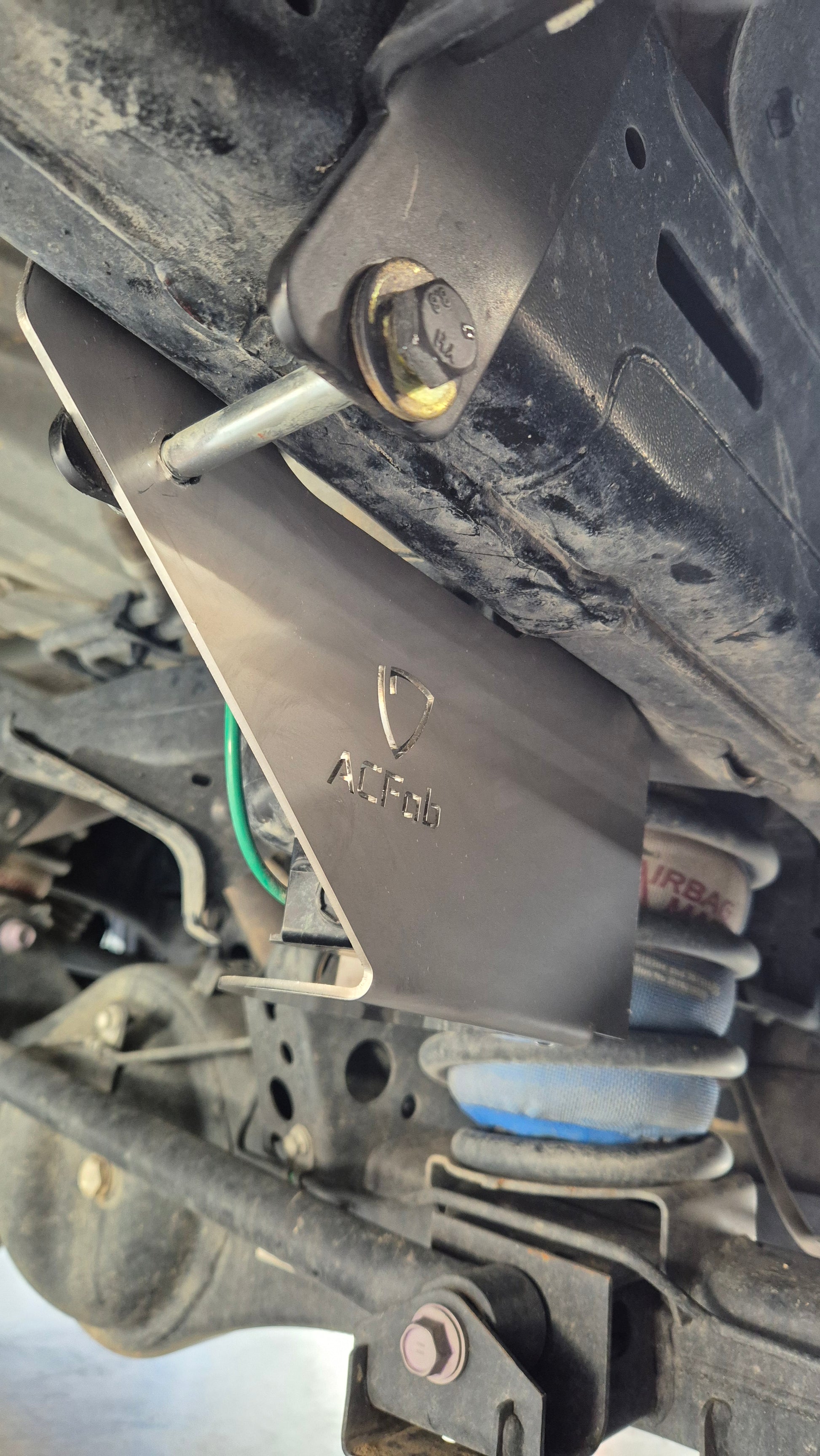 Close-up of a mechanical component with a brand logo on a vehicle engine.